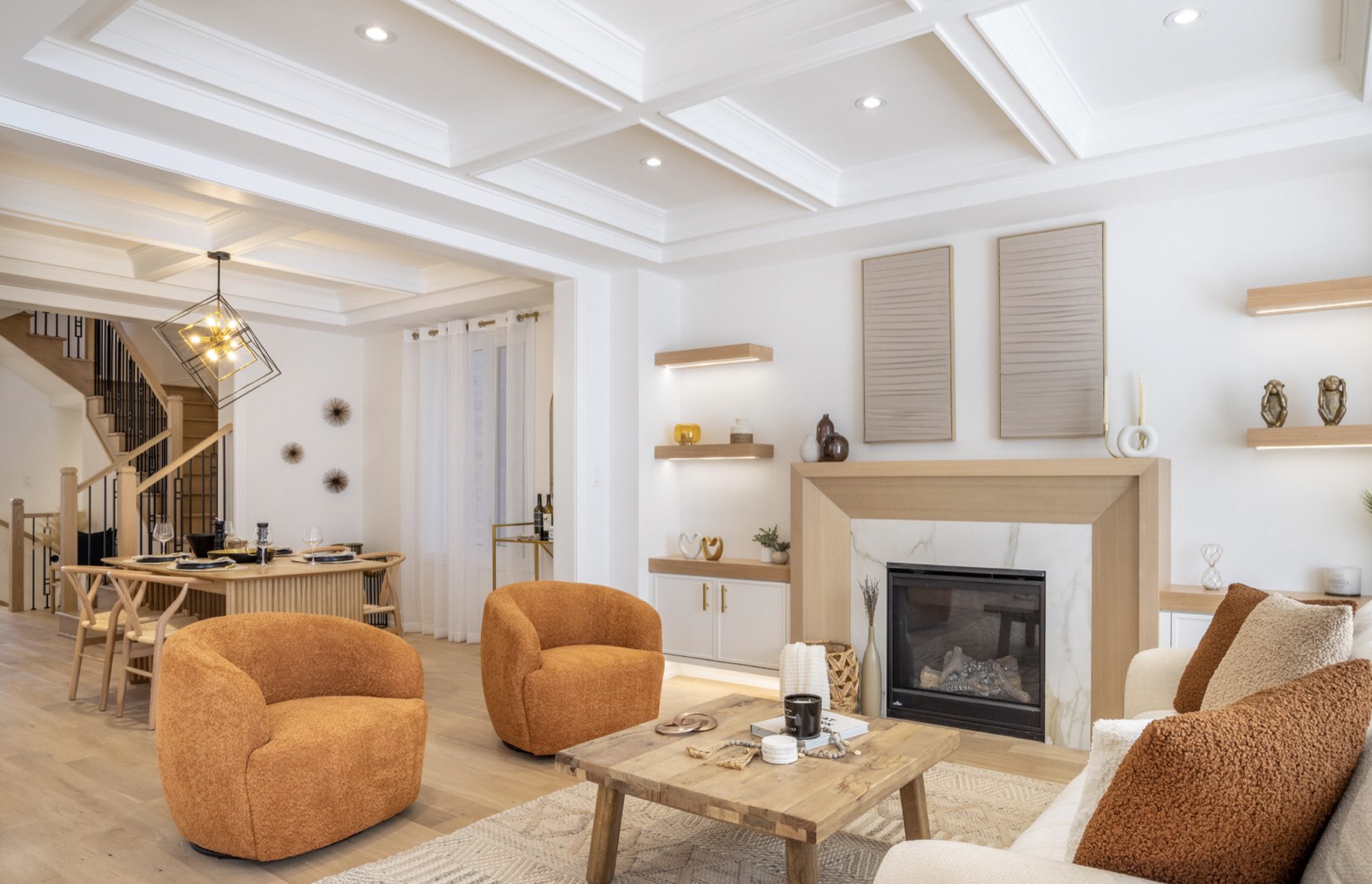 Open-concept living room with coffered ceiling and fireplace in a Lakeview home